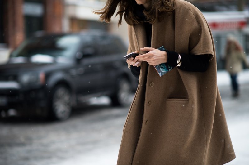 Dívka v nadměrném kabátě s krátkým rukávem