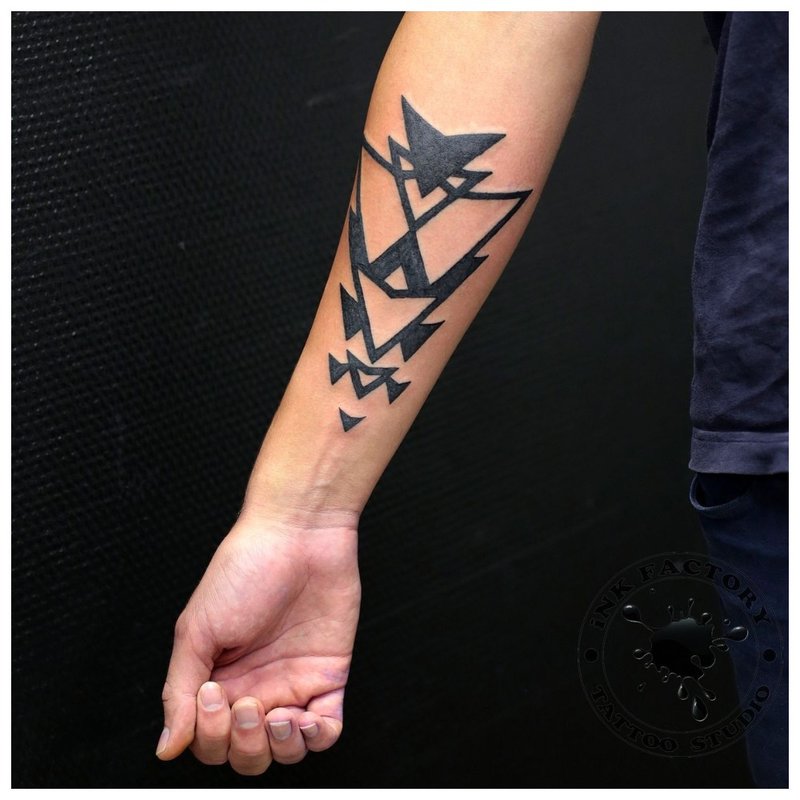 Tatouage géométrique sur le bras d'un homme