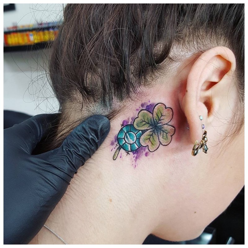 Beautiful bright tattoo on the girl’s neck