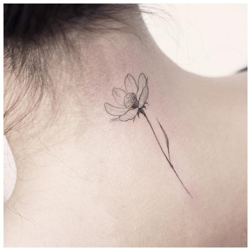Delicate flower tattoo on the neck