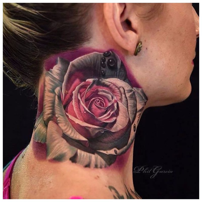 Large flower - a tattoo on the girl’s neck